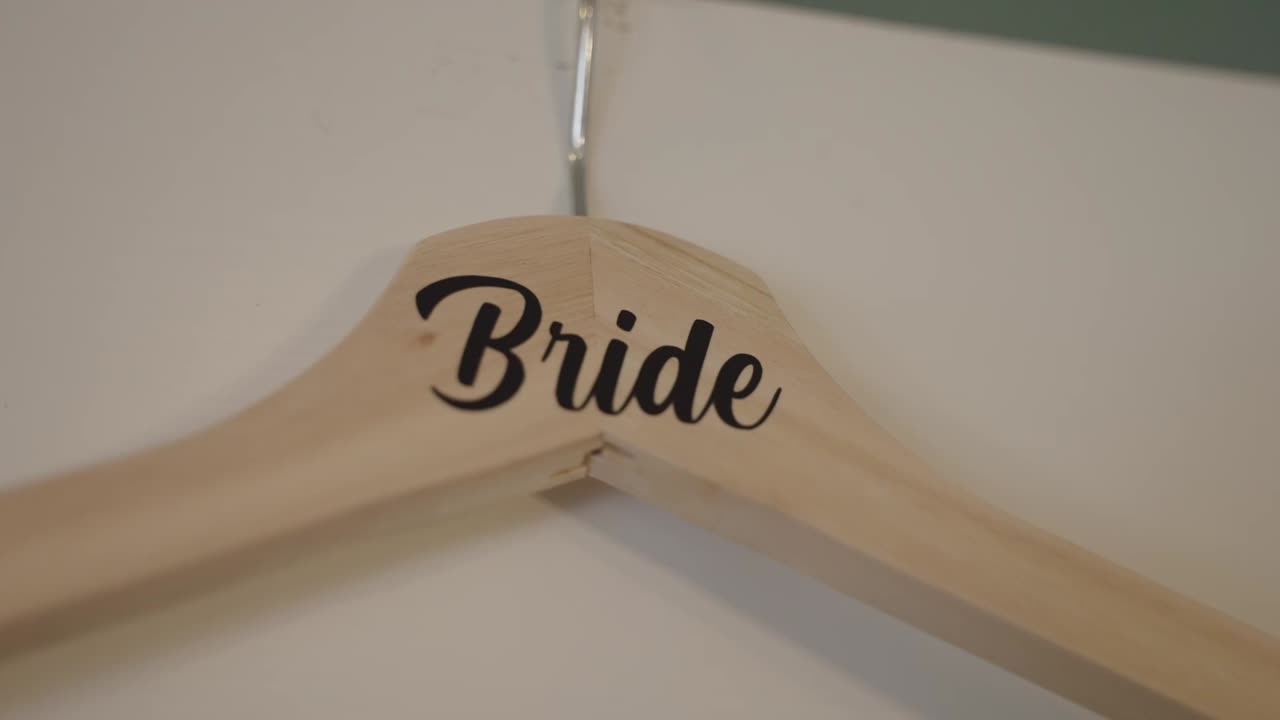 Close up of a clothing hanger with "Bridge" printed for hanging wedding dress