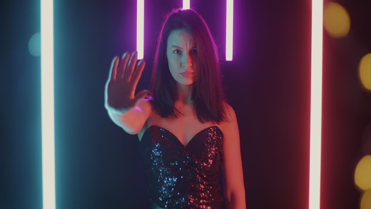 Woman in a sequin dress under neon lights