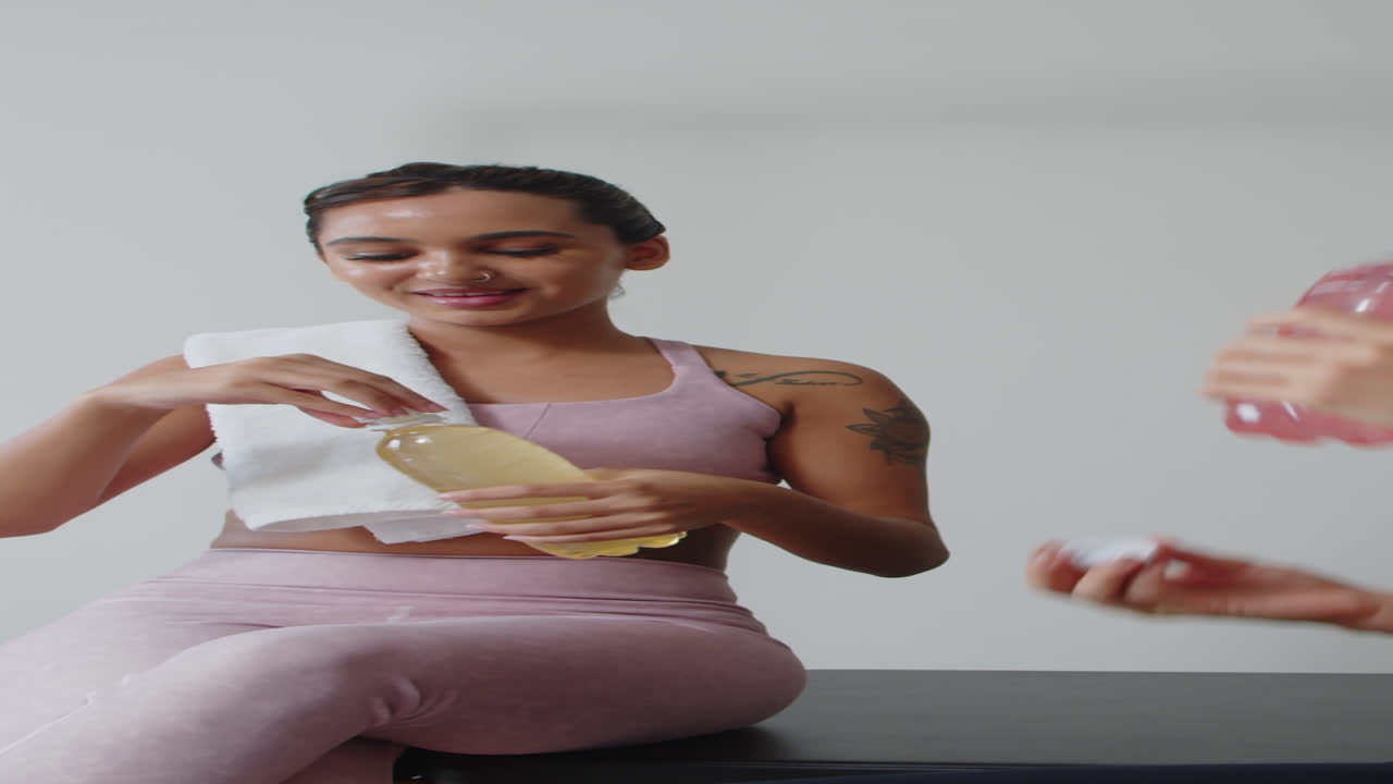Sportswomen Having Healthy Drinks after Workout