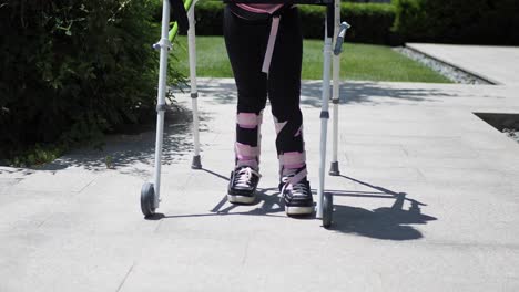 child with leg brace using walker