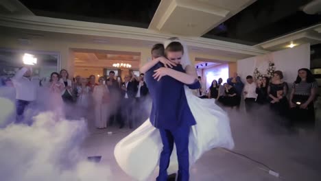 beautiful young newlyweds dancing their first dance shrouded by white fume beautiful young newlyweds dancing their first dance shrouded by white fume