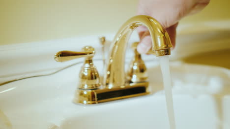 open a tap with water in a luxurious bathtub