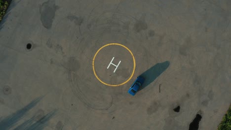 ariel overhead shot drift sports car in a circle