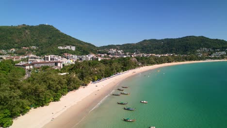 boats-anchored-in-the-tropical-turquoise-blue-andaman-sea-at-Karon-beach-on-a-sunny-summer-day-in-Phuket-Thailand