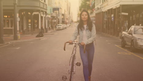 spots of light against portrait of asian woman with bicycle walking at the beach