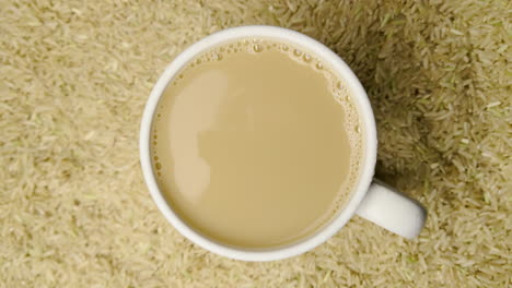 coffee droplet falling into a cup of creamy brown coffee