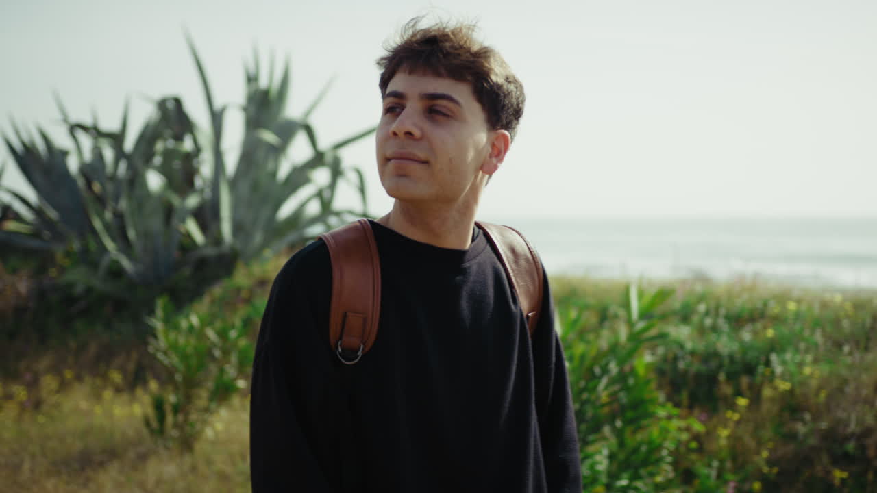 Relaxed And Happy Man Having A Walk On The Sidewalk Near The Sea
