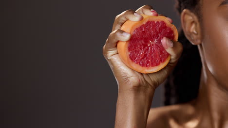 woman squeezing a grapefruit