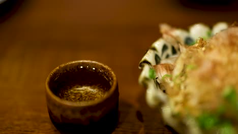 pouring and enjoying sake with a meal