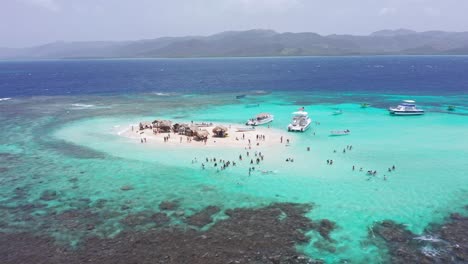 people bathing in turquoise waters of cayo arena or paradise island