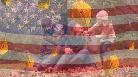 animación de hojas y bandera estadounidense sobre familia caucásica sonriendo en el bosque