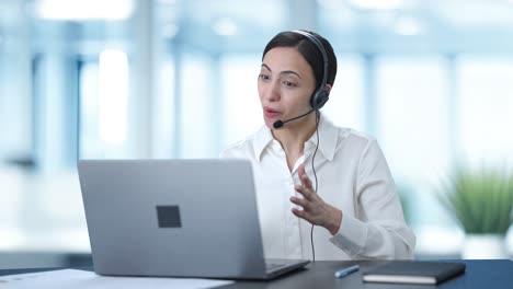 Happy-Indian-call-center-girl-talking-to-customer-through-video-call