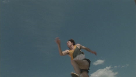 a female athlete competes in long jump