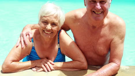 Portrait-of-senior-couple-relaxing-together-in-pool