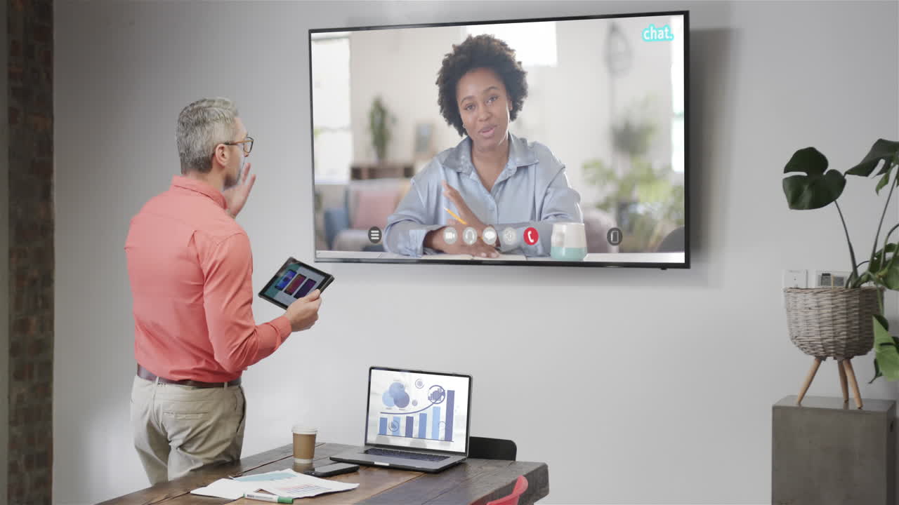 Caucasian businessman on video call with african american female colleague on screen