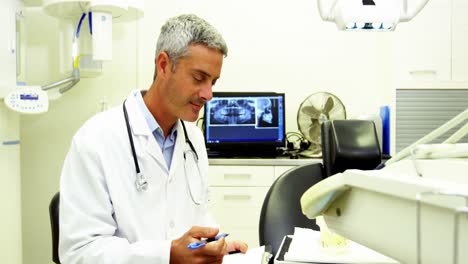 Dentist-smiling-at-camera