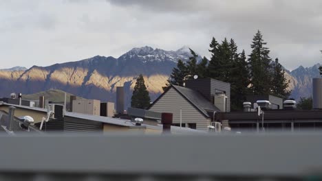 mountain range during cloudy sunset with ski town in the foreground
