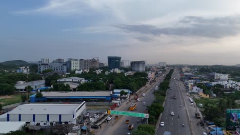 panoramic drone shot of zoho corporation amidst greenery and urban landscape near highway