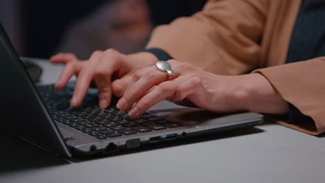 close-up of businesswoman hands sitting at desk table in business company