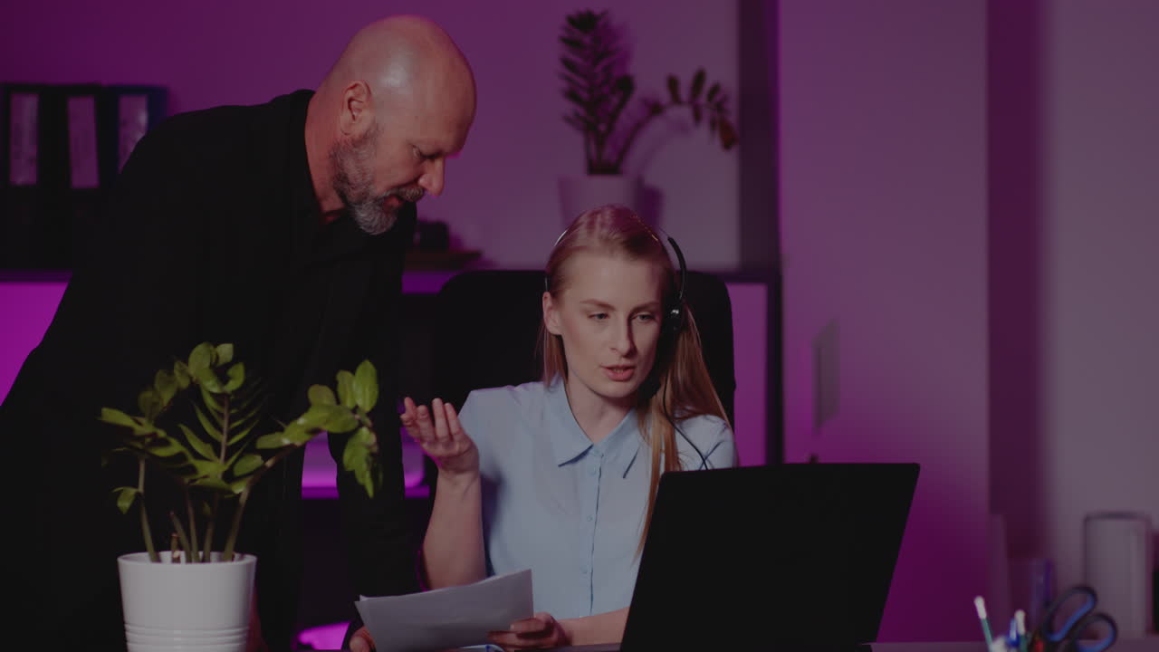 Office meeting with headset-wearing employee