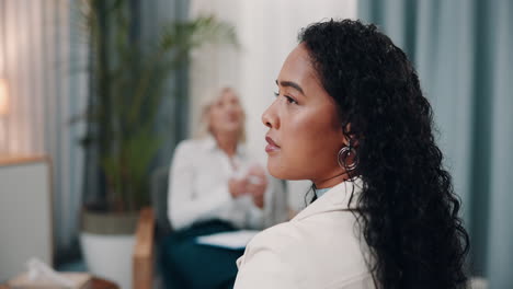 woman listening attentively to her therapist during a therapy session.