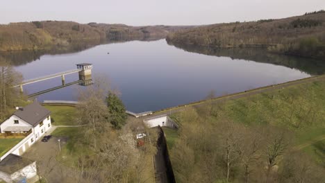 an industrial, minimal intake tower on an artificial lake in west germany