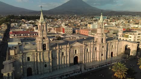 arequipa's grand cathedral with volcano backdrop seen from above at golden hour