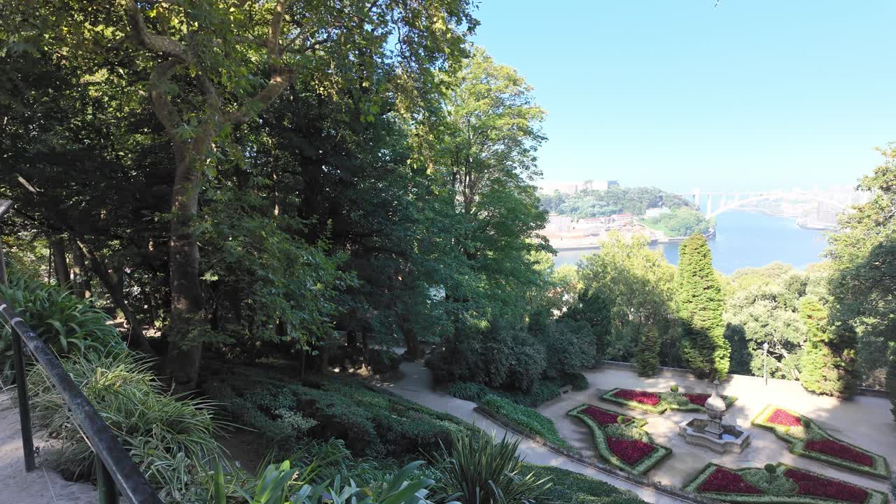 A lush garden scene with walking paths and greenery in the Porto Crystal Palace Gardens