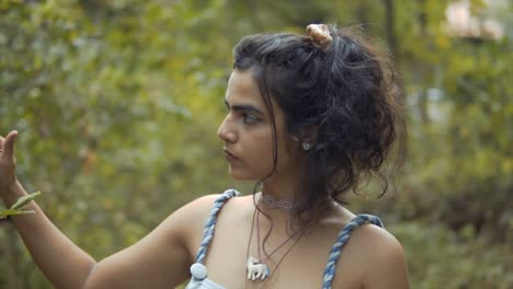 close-up of a girl with dark hair exploring a tropical forest, in slow motion