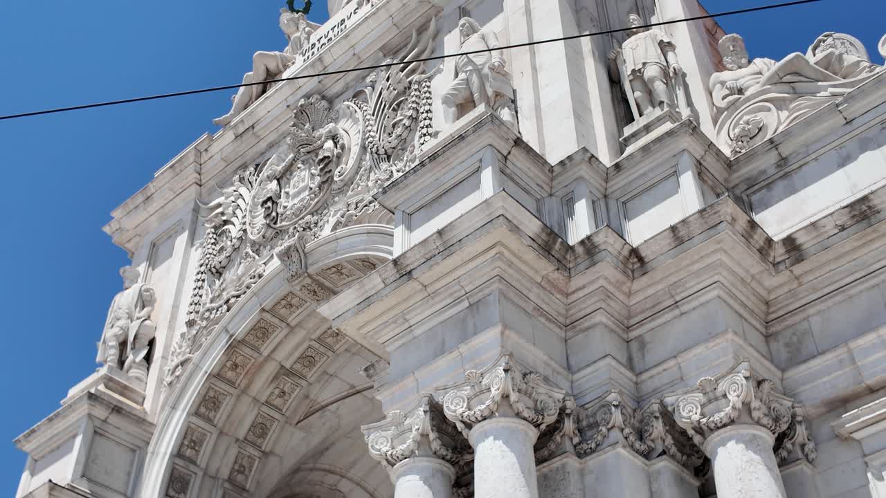 Detail of the triumphal arch on Augusta Street in Lisbon, Portugal, showing its imposing columns and intricate carvings.Tilt up