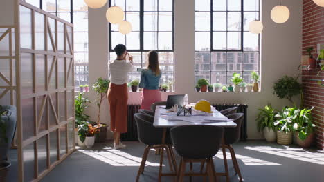 business women architects discussing construction project team of engineers brainstorming sharing ideas planning successful development enjoying window view in modern office