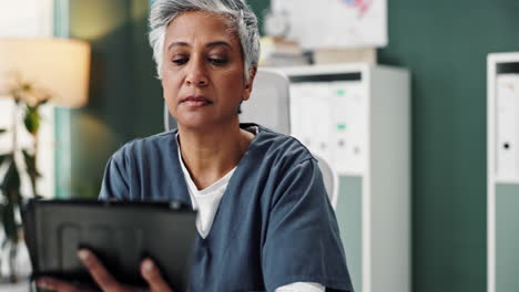 female doctor using a tablet in her office