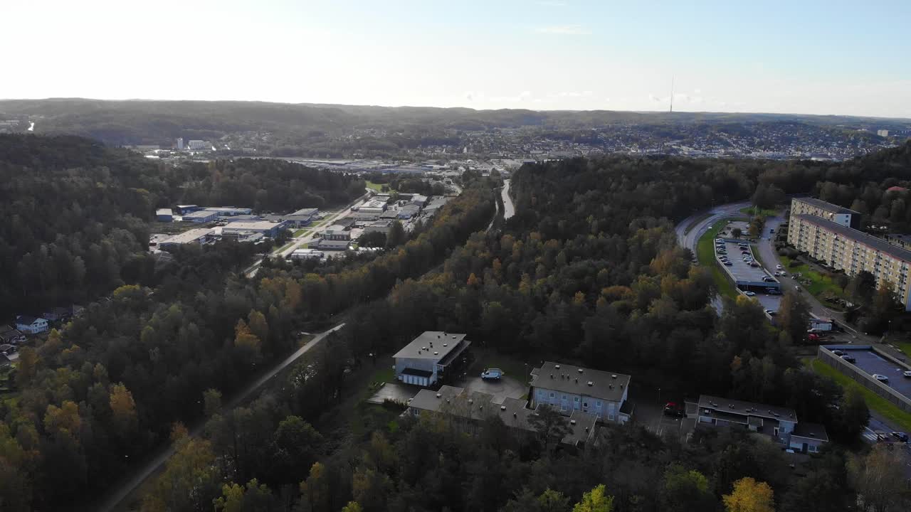 Drone takeoff from scenic woodland area showing apartments, Gothenburg