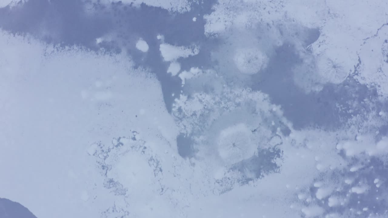 Top down view of a frozen lake in rural Finland during midwinter. Aerial shot