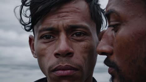 two men exchanging secrets by whispering in each other's ear, creating an atmosphere of intrigue and confidentiality against a cloudy sky backdrop