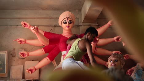 in kumortuli, idol artists are making idols of durga, the revered deity of hinduism. the work of making these idols starts from june and these potters make many idols till november.