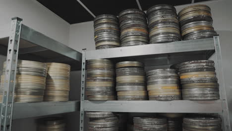 Old-round-metal-boxes,-in-a-dusty-vault-and-leaves