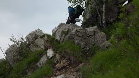 lombardy, italy - a mountain climber ascends the rugged slopes of grignetta - medium shot