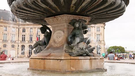 fountain with sculptures in a busy place de la bourse square