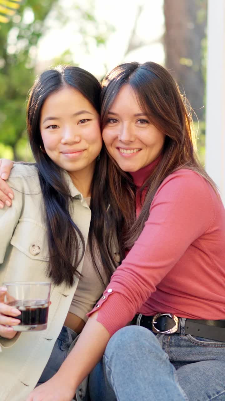 Best friends smiling at camera while chilling in the garden