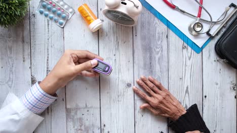 doctor checking patient's pulse oximeter