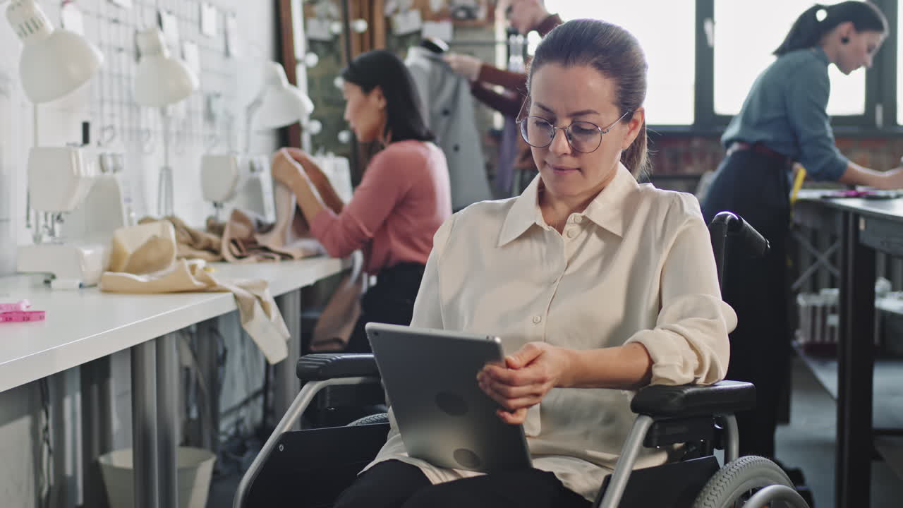 Female Fashion Designer in Wheelchair with Tablet