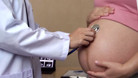 pregnant woman and gynecologist doctor at hospital