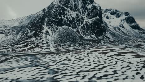 above view of flakstad church in snowscape at ramberg in lofoten islands, norway. aerial drone shot