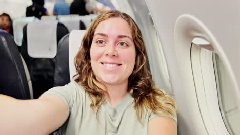 woman smiling by an airplane window at night