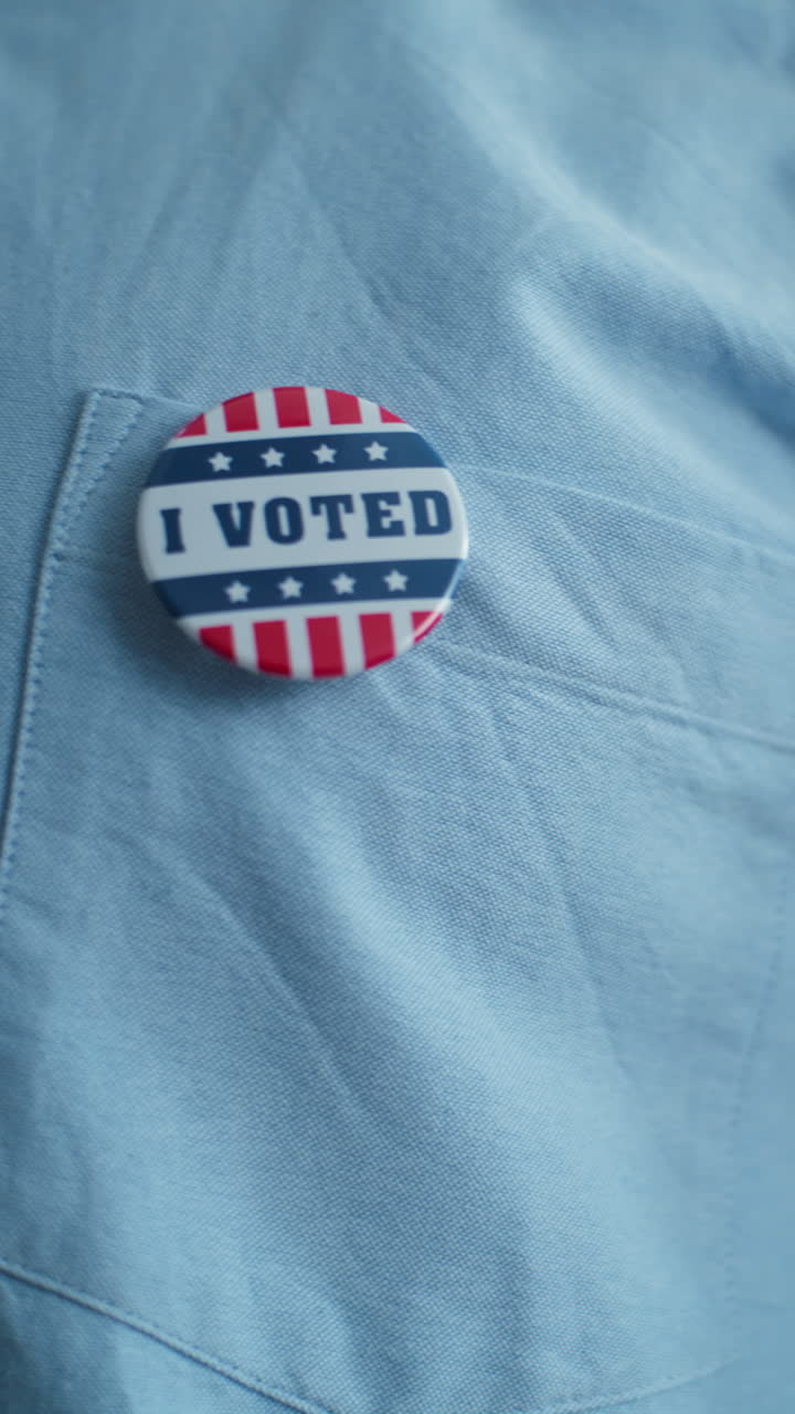 Businessman Puts on Badge with American Flag Logo and Inscription i Voted Close up of Anonymous Businessman or Man Putting on Badge with American Flag Logo and Inscription i Voted us Citizen at Polling Station during Elections National Election Day in the United States