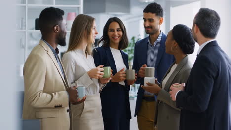 diverse business professionals chatting during a coffee break