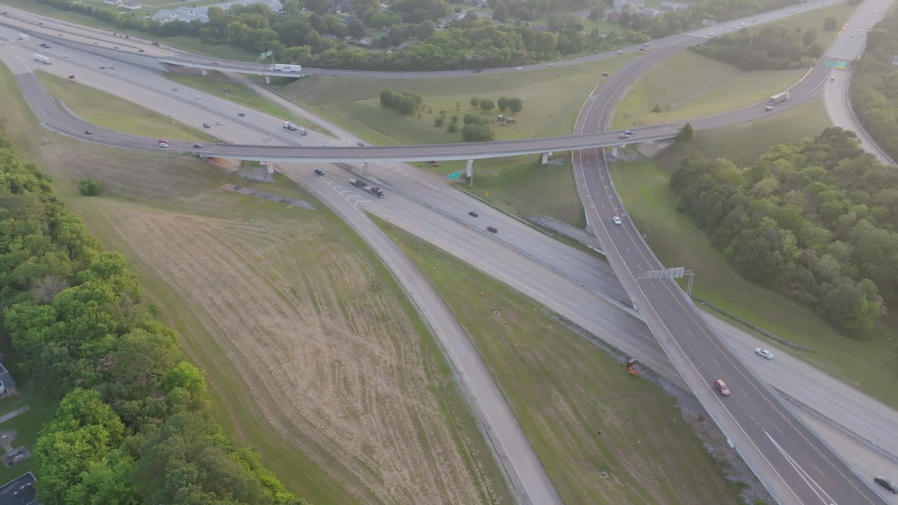 Aerial drone footage flying away from the Highway 153 and Interstate 75 Interchange in Chattanooga, TN during the golden hour sunset