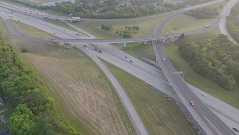 aerial drone footage flying away from the highway 153 and interstate 75 interchange in chattanooga, tn during the golden hour sunset