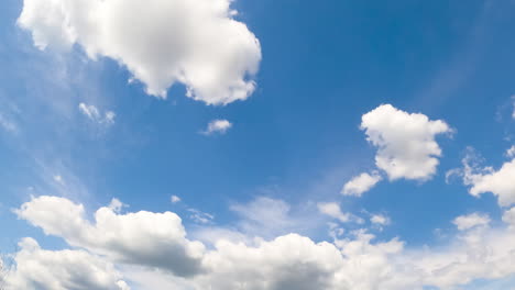 light blue summer sky with fluffy soft clouds. white cloudscape formation from low angle view.